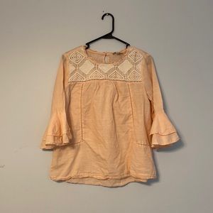 Peach colored women’s blouse